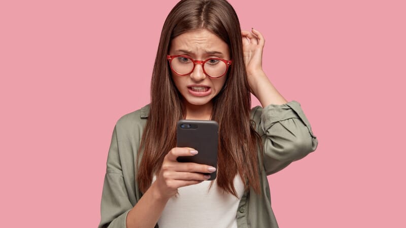 Frustrated student looking at a smartphone