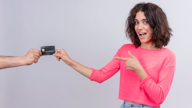 Woman handing over a credit card